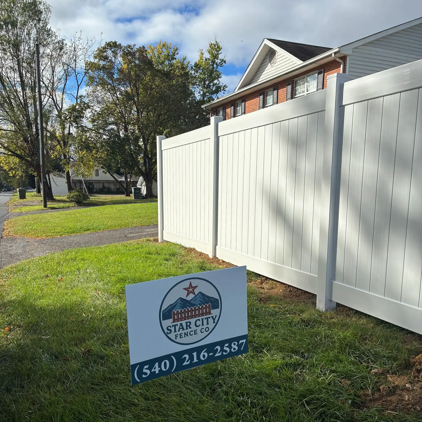 White vinyl privacy fence installed by Star City Fence Co after removing an old chain link fence