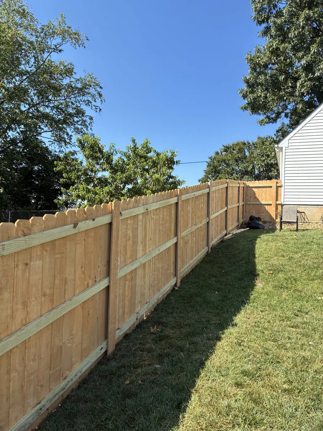 Long run of new wood privacy fence installed by Star City Fence Co